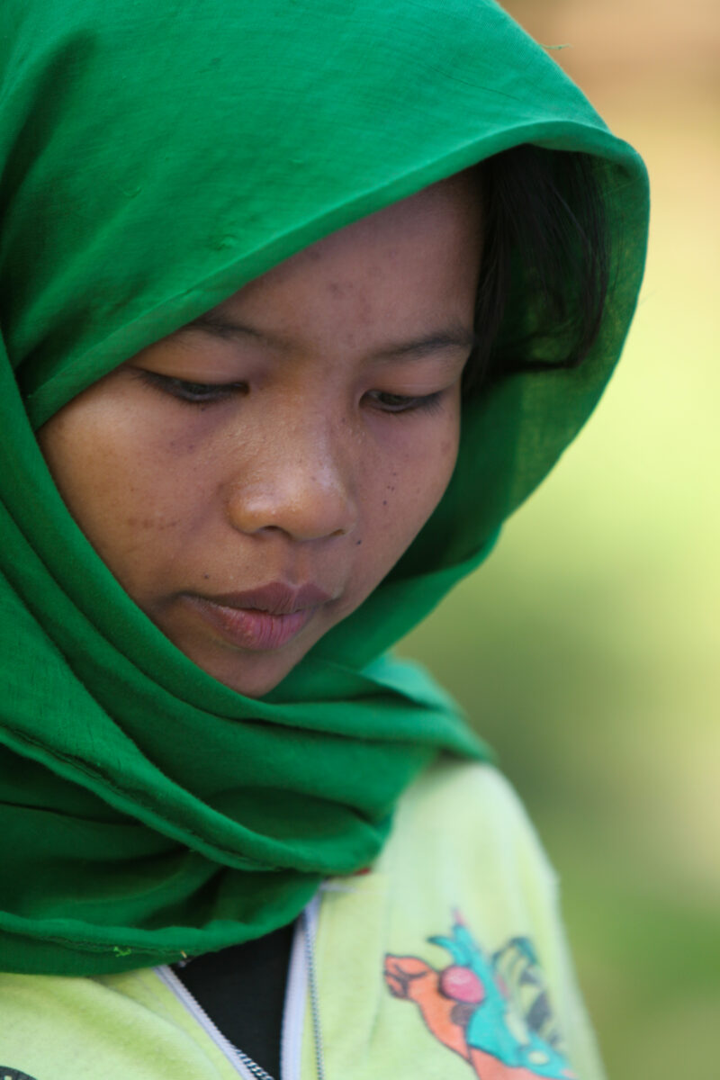 Learning to Read — Women in a Muslim village in Rural Cambodia gather to learn how to read, in a ADRA program that has come to their village — Cambodia, Wome...