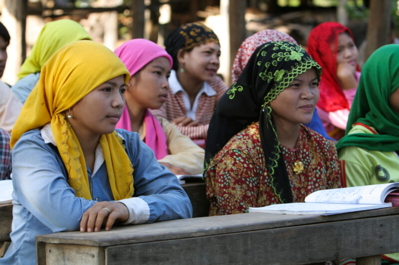 Learning to Read — Women in a Muslim village in Rural Cambodia gather to learn how to read, in a ADRA program that has come to their village — Cambodia, Wome...