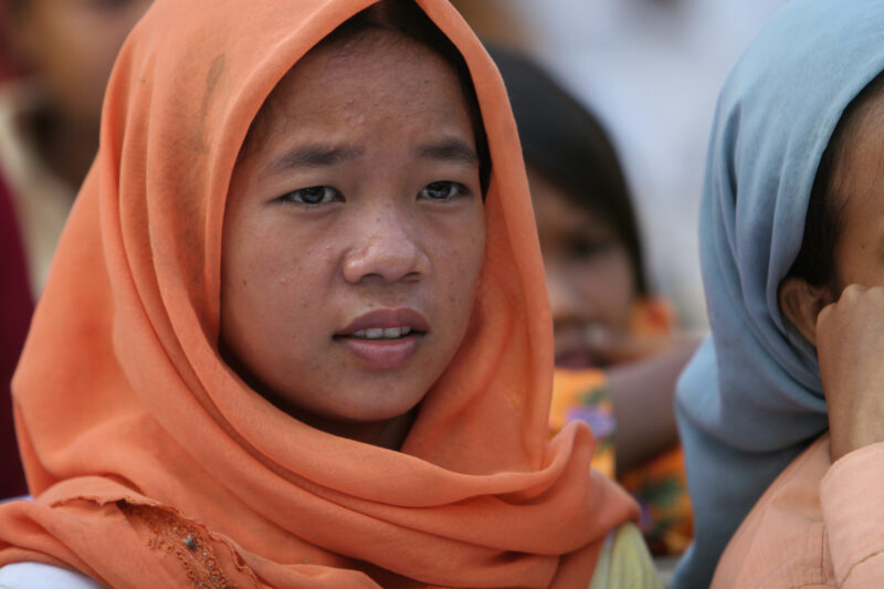 Learning to Read — Women in a Muslim village in Rural Cambodia gather to learn how to read, in a ADRA program that has come to their village — Cambodia, Wome...