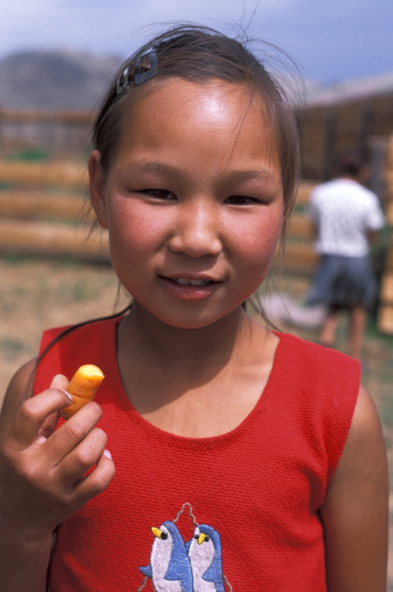 Eating a Carot in Mongolia — People in Mongolia learn how to grow and process food from their own gardens, in a program run by ADRA — Mongolia, ADRA, Poverty...