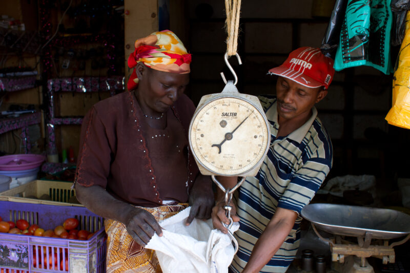 Buying Beans and Maize in Kenya — Woman buys beans and maize at a store in Kenya — food, market, store, beans, maize