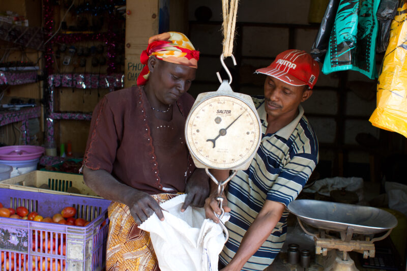 Buying Beans and Maize in Kenya — Woman buys beans and maize at a store in Kenya — food, market, store, beans, maize