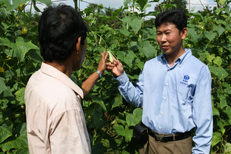 Agricultural Instruction in Cambodia — Stock Image of rural farmers getting agricultural instruction from an ADRA specialist. — Cambodia, farming, agricultur...