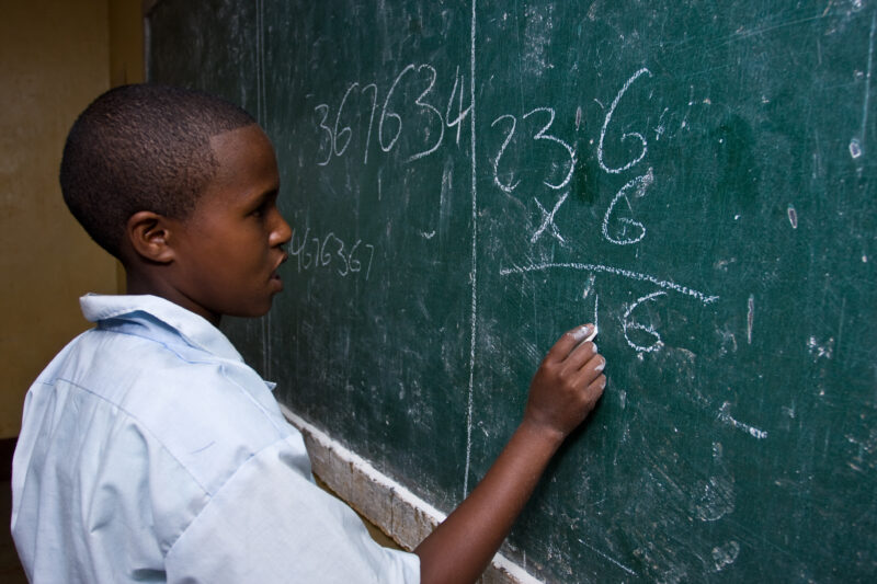 Girl at the Blackboard — Students at an Elementary school in the Hanang district of Tanzania, Africa — ADRA, Africa, Development, Poverty, Tanzania