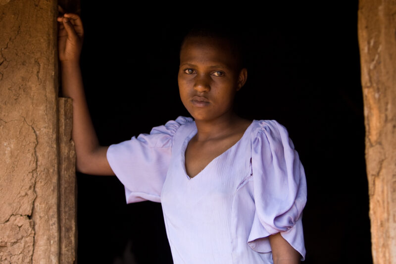 Girl in Doorway — Girl in Tanzania stands in the Doorway of her home. — ADRA, Africa, Development, Poverty, Tanzania