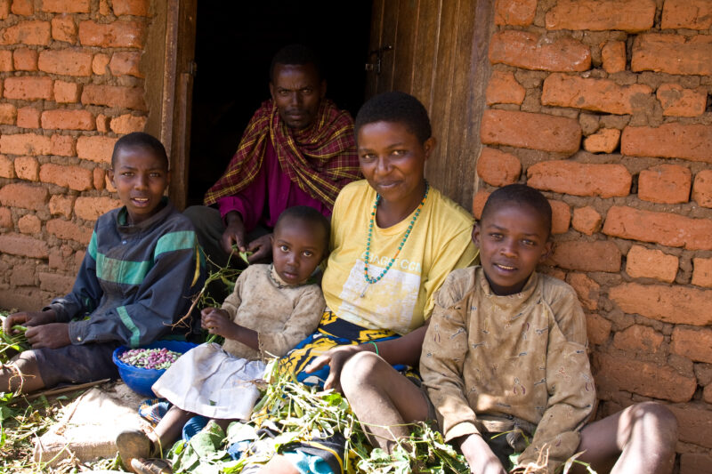 Shelling Beans — Family in rural Tanzania work together to shell the beans they have just harvested from their garden. — ADRA, Africa, Development, Poverty, ...