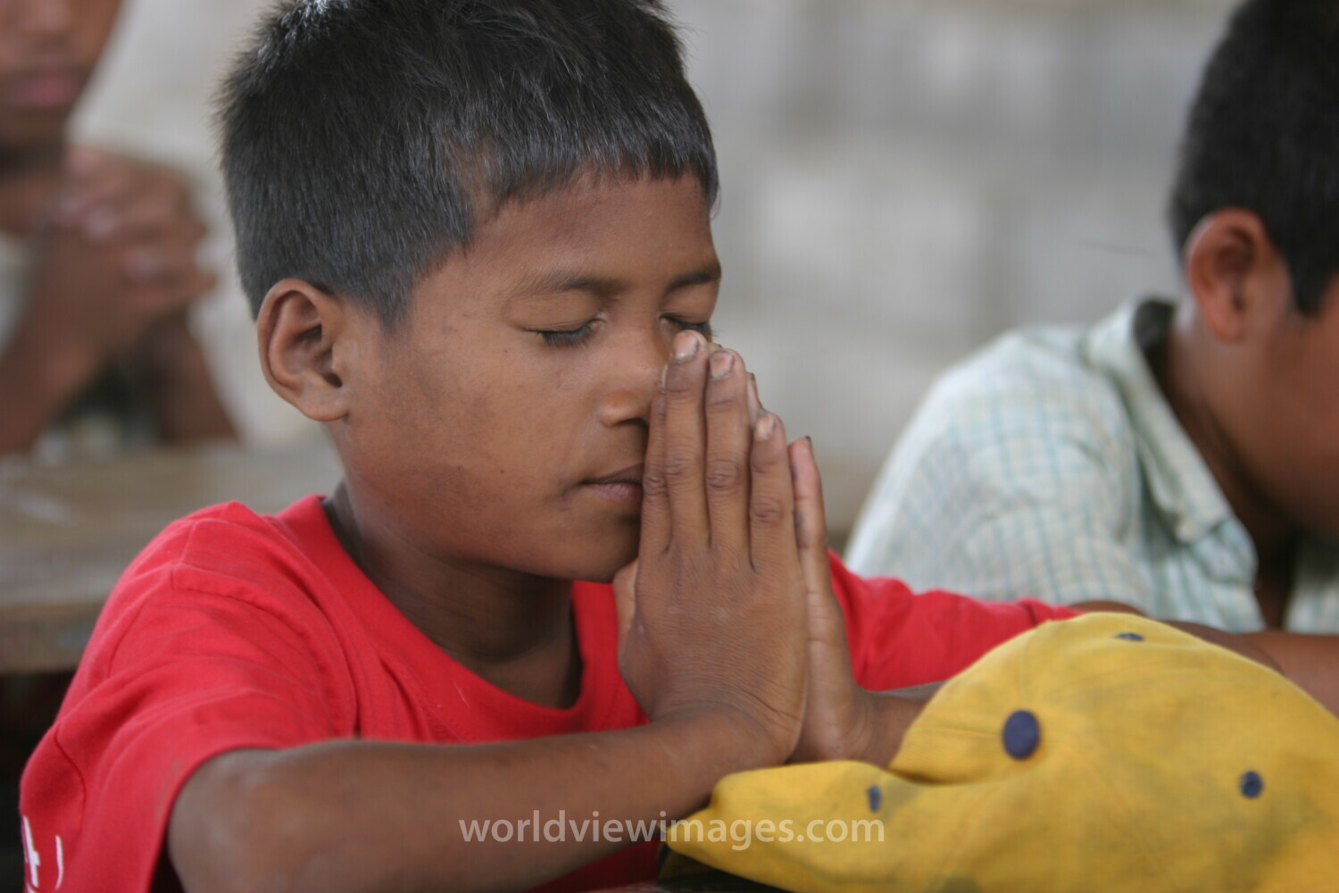 Child in Cambodia Praying