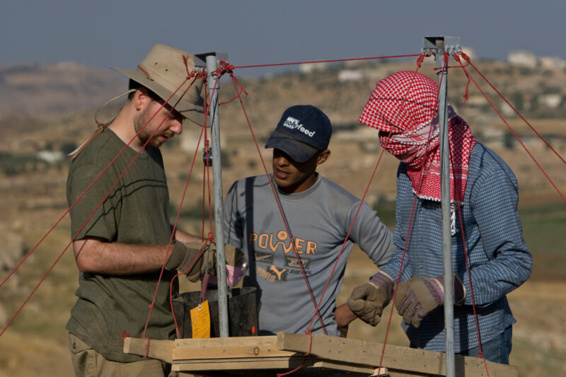Sifting for Treasure — Students and Local workers, hired for the dig session, sift through the dirt that comes out of the squares, to catch small items like ...