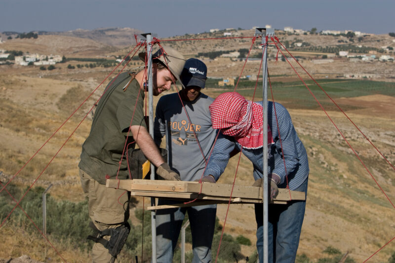 Sifting for Treasure — Students and Local workers, hired for the dig session, sift through the dirt that comes out of the squares, to catch small items like ...