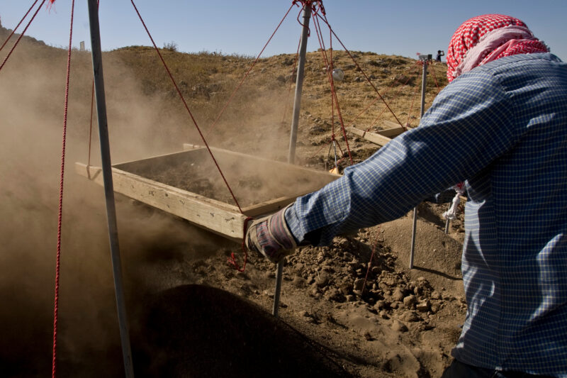 Sifting for Treasure — Students and Local workers, hired for the dig session, sift through the dirt that comes out of the squares, to catch small items like ...