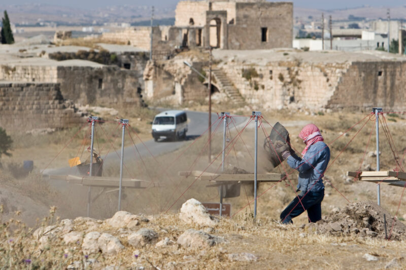 Sifting for Treasure — Students and Local workers, hired for the dig session, sift through the dirt that comes out of the squares, to catch small items like ...