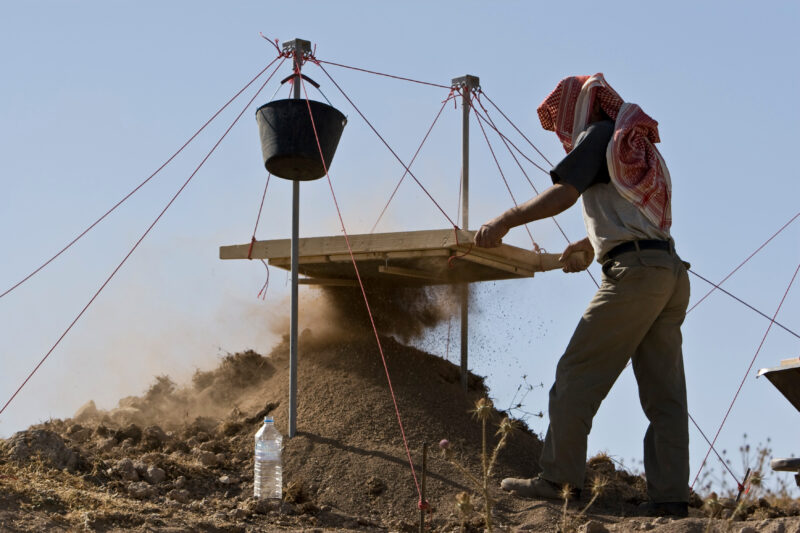Sifting for Treasure — Students and Local workers, hired for the dig session, sift through the dirt that comes out of the squares, to catch small items like ...