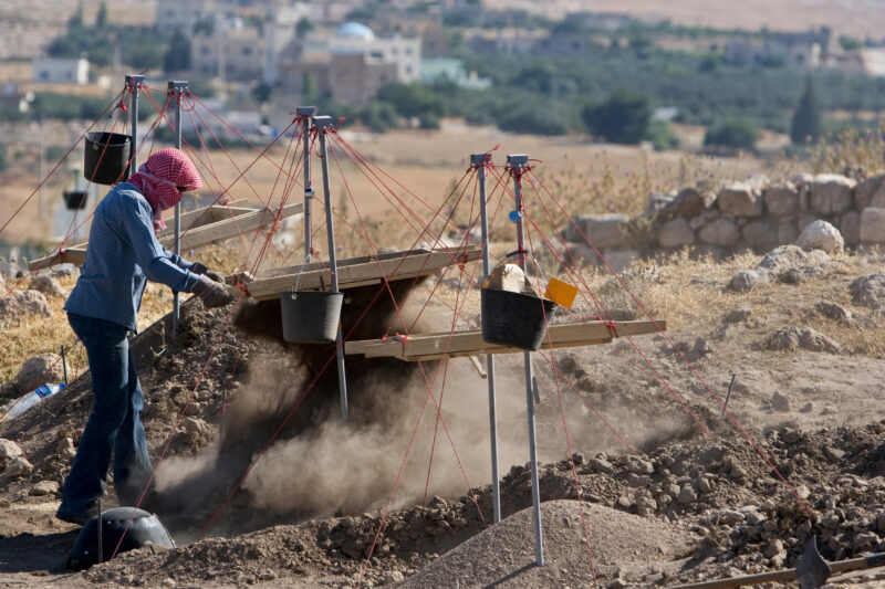 Sifting for Treasure — Students and Local workers, hired for the dig session, sift through the dirt that comes out of the squares, to catch small items like ...