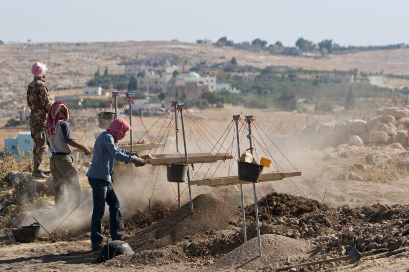 Sifting for Treasure — Students and Local workers, hired for the dig session, sift through the dirt that comes out of the squares, to catch small items like ...