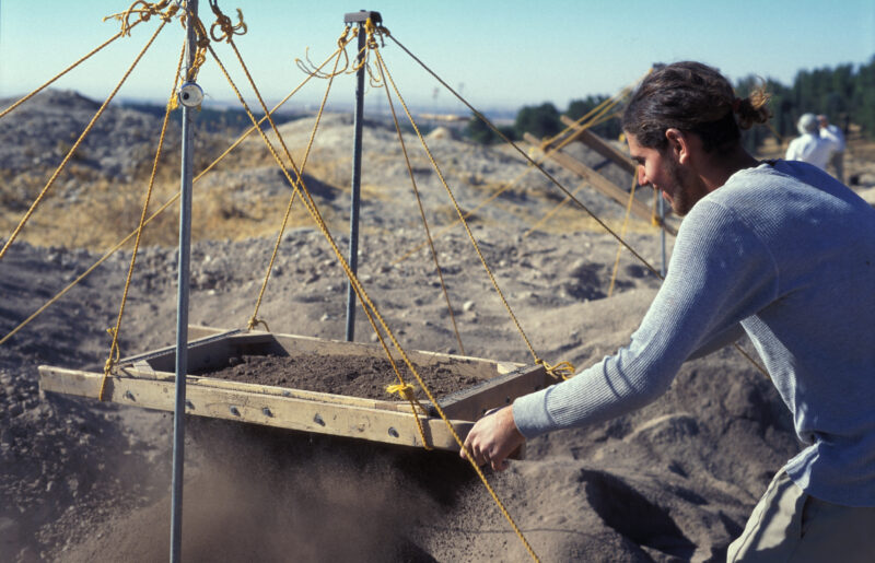 Sifting for Treasure — Students and Local workers, hired for the dig session, sift through the dirt that comes out of the squares, to catch small items like ...