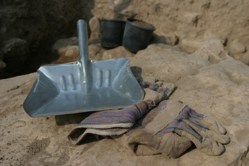 Dustpan and Gloves — A Dustpan is a handy tool to have when excavating a square at an archelogical site. — Israel, Hazor, Archaeology, dustpan, gloves