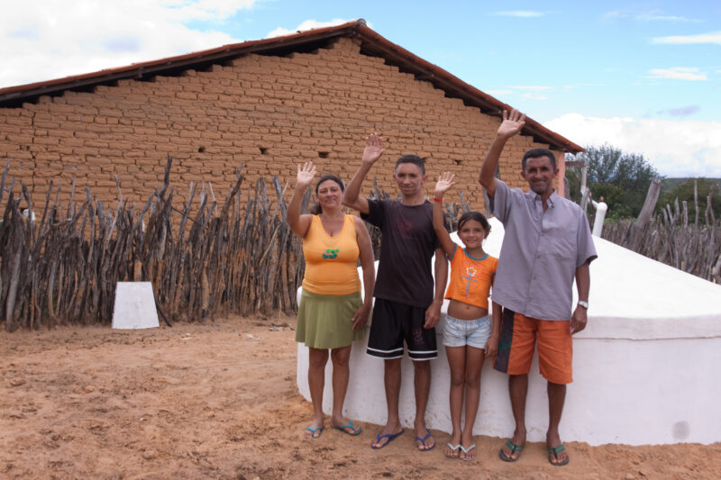 A Wave of Thanks — Family waves a thankyou to ADRA for the new water storage tank they have had built by ADRA — Brazil, South America, water, water security,...