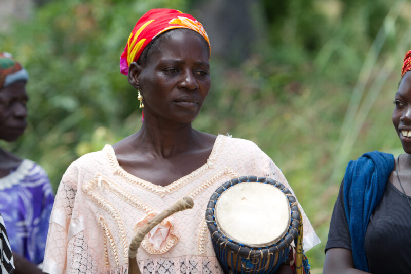 Woman in Burkina Faso — Woman living in a rural village in Burkina faso, Africa plays drum. — Africa, West Africa, Burkina Faso, poor, poverty