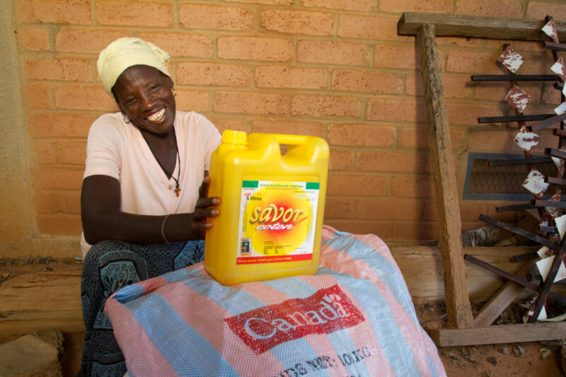 Receiving Food — Woman with disability poses with food that she has received from an Emergency food Distribution program sponsored by the Canadian Foodgrains...