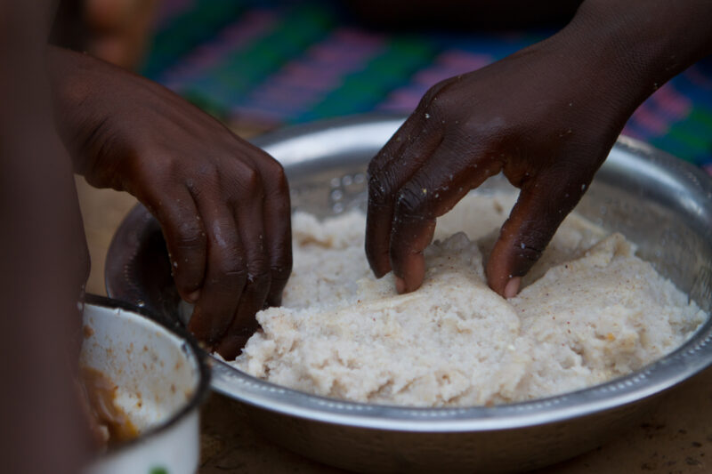 Taking Food — Closeup of hands taking corn meal. — Africa, West Africa, Burkina Faso, poor, poverty