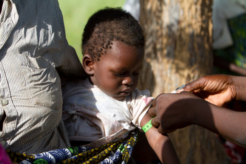 Checking for Malnourishment — Health workers check babies for signs of malnourishment by measuring their arms, at a remote village in Burkina Faso, Africa th...