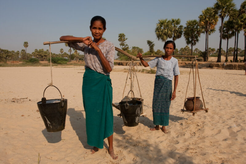 Myanmar — Woman return from well in the "dry Zone" of Burma, with water buckets on a ballancing stick. — ADRA, Burma, Myanmar, women, water