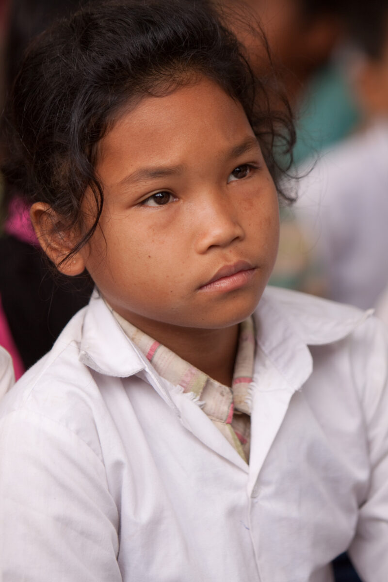 Faces of Cambodia — People living in poverty in rural Cambodia, listen to lecture on Health and Sanitation — Cambodia, ADRA, faces, children, girls