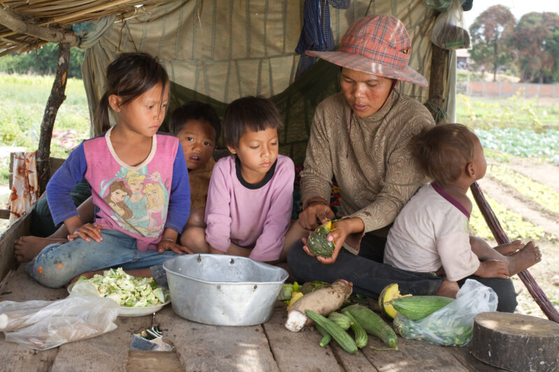 Cooking the Meal — Mother gathers her children together under a shelter to prepare a simple meal in rural Cambodia. — Cambodia, food, food security, cooking,...
