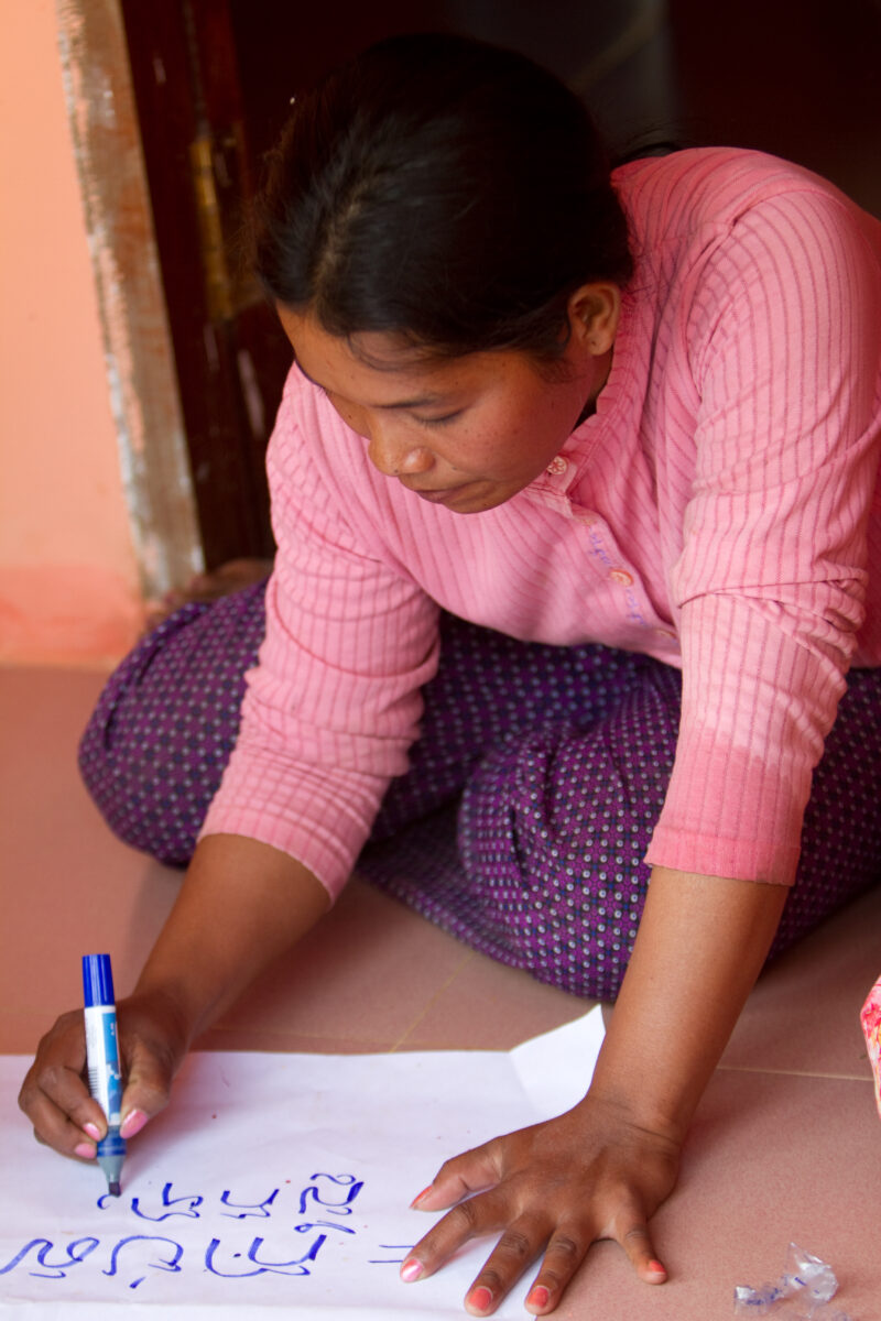 Literacy Program in Cambodia — Stock Images of Cambodia: Woman in literacy program demonstrates her new writing skills — ADRA, Cambodia, Reflect, Southeast A...