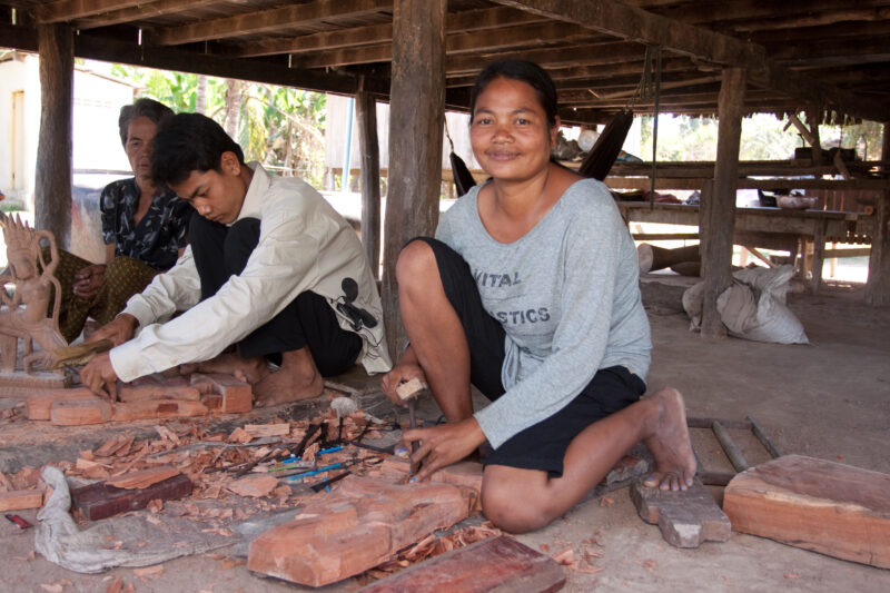 Carving Souvenirs in Cambodia — Woman carves statues from teak wood to make souvenirs for tourists as a way to make income for her family. — Cambodia, woman,...