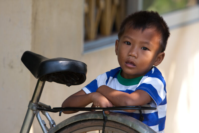 Children of Cambodia — Stock Image of a boy standing with his bike in Cmabodia — Cambodia, boy, boys, faces, bike