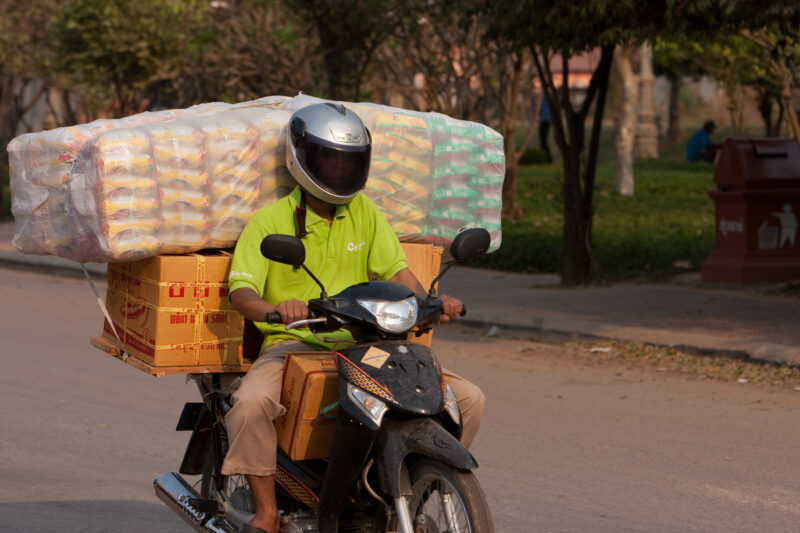 Delivery Man in Cambodia — Man with boxes of items to deliver on his motor bike. — Cambodia, man, men, delivery, moter bike