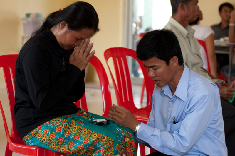 Praying in Cambodia — Couple prays together in Cambodia — Cambodia, Christian, prayer, praying, church