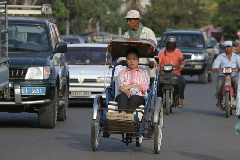 Cyclo Driver in Cambodia — Stock image of cyclo driver working the streets of Phnom Penh, Cambodia — Cambodia, street, streets, traffic, Phnom Penh