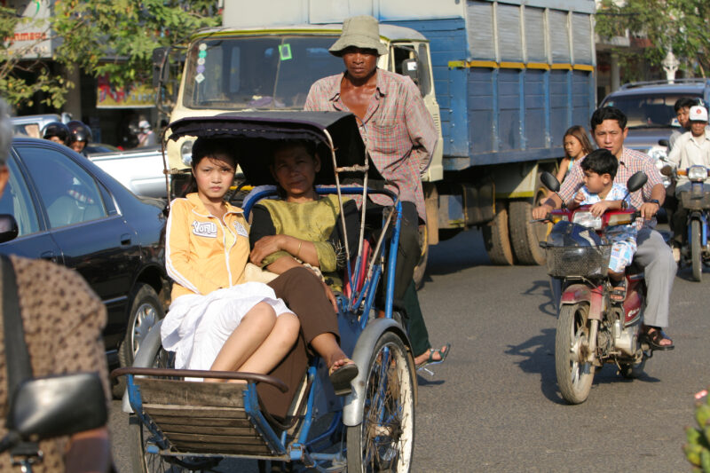 Cyclo Driver in Cambodia — Stock image of cyclo driver working the streets of Phnom Penh, Cambodia — Cambodia, street, streets, traffic, Phnom Penh
