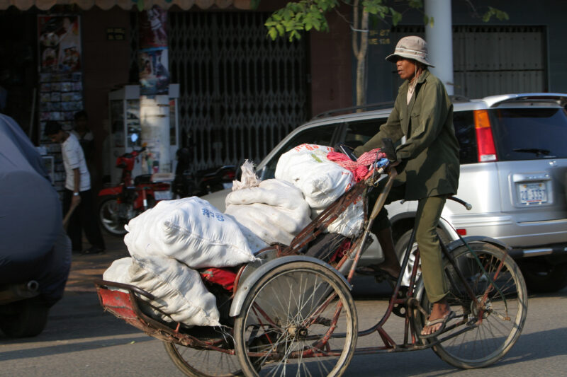Cyclo Driver in Cambodia — Stock image of cyclo driver working the streets of Phnom Penh, Cambodia — Cambodia, street, streets, traffic, Phnom Penh