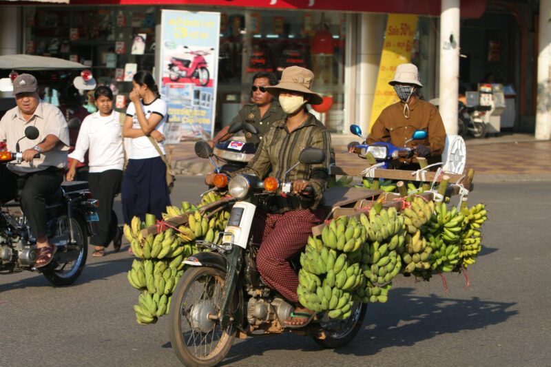 Delivery Bike in Cambodia — Man delivers his bananas to market, using his moterbike. — Cambodia, street, streets, traffic, motorcycle