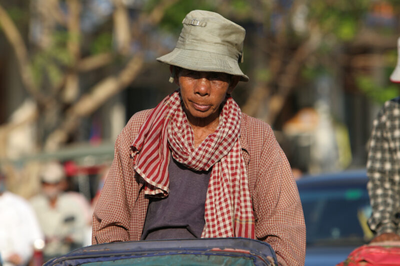 Cyclo Driver in Cambodia — Stock image of cyclo driver working the streets of Phnom Penh, Cambodia — Cambodia, street, streets, traffic, Phnom Penh