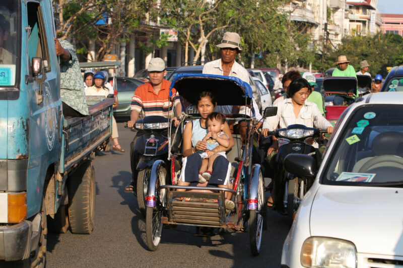 Cyclo Driver in Cambodia — Stock image of cyclo driver working the streets of Phnom Penh, Cambodia — Cambodia, street, streets, traffic, Phnom Penh