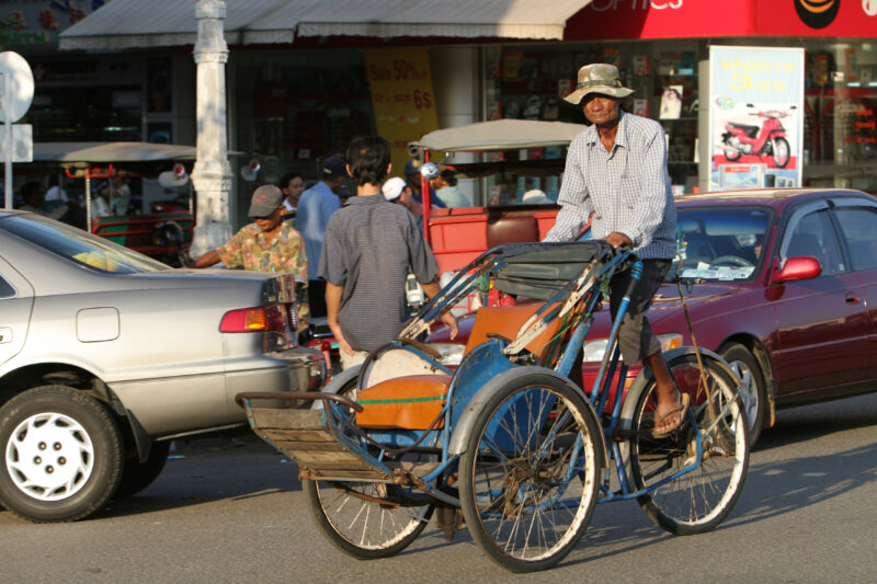 Cyclo Driver in Cambodia — Stock image of cyclo driver working the streets of Phnom Penh, Cambodia — Cambodia, street, streets, traffic, Phnom Penh