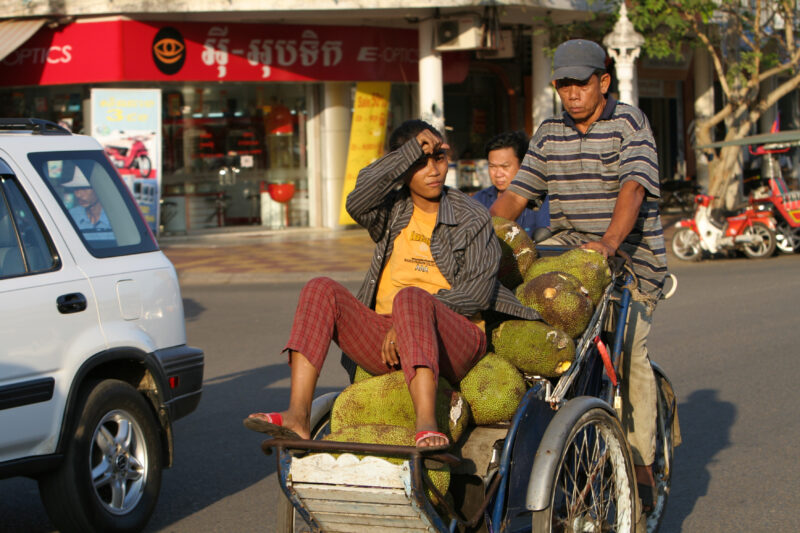 Cyclo Driver in Cambodia — Stock image of cyclo driver working the streets of Phnom Penh, Cambodia — Cambodia, street, streets, traffic, Phnom Penh