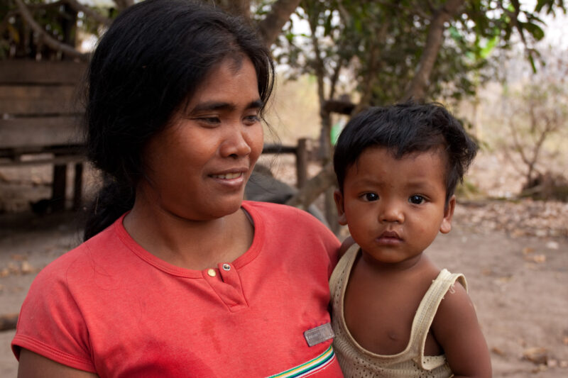Mother and Baby in Cambodia — Mother looks at her baby in a rural village in Cambodia — Cambodia, Rural, mother, baby, babies