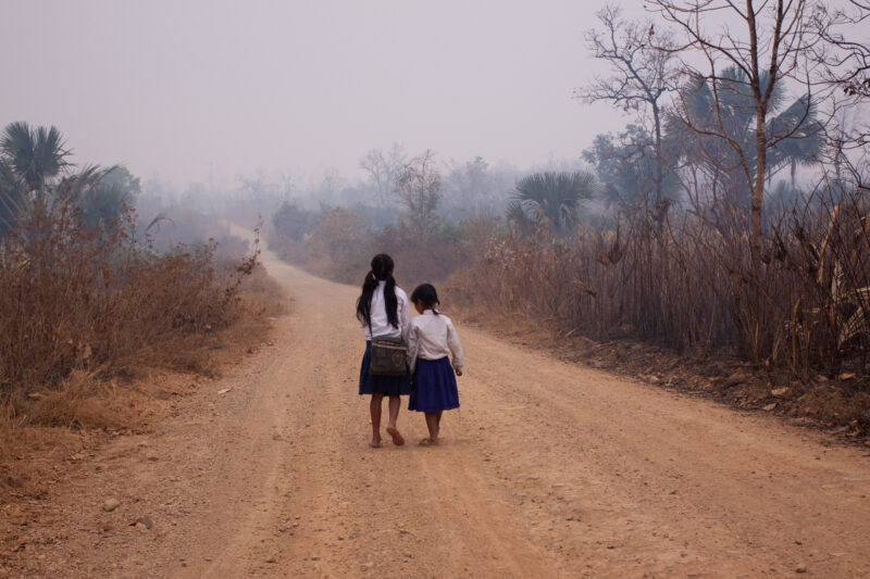 Walking to School in Cambodia — Girls walk to school in the morning fog in rural Cambodia — Cambodia, Rural, road, walking, school