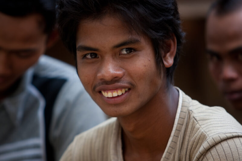 Man in Cambodia — Man in a mens group poses for camera — Cambodia, people, faces, men, Khmer