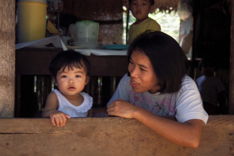 Mother and Baby in Window — Stock Image of mother and baby in the window of their home in the Philippines. — Babies, Children, faces, Philippines, mother