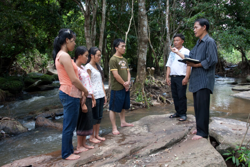 Christian Baptism in Laos — Young person becomes an Adventist Christian in the country of Laos, and is baptized in a mountian stream. — Laos, Southeast Asia,...