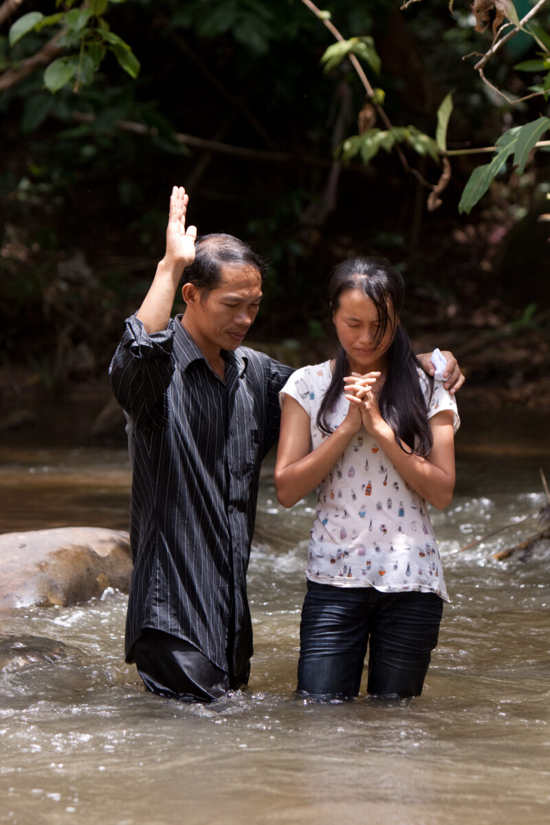 Christian Baptism in Laos — Young person becomes an Adventist Christian in the country of Laos, and is baptized in a mountian stream. — Laos, Southeast Asia,...