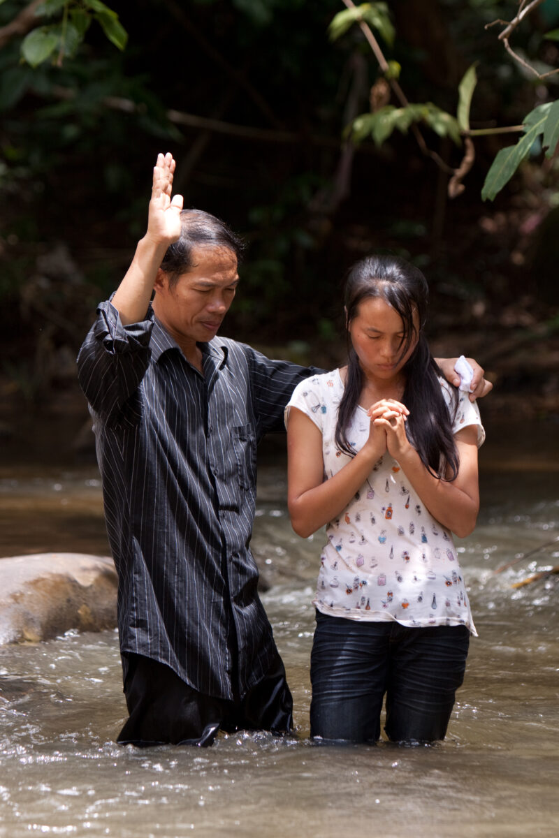 Christian Baptism in Laos — Young person becomes an Adventist Christian in the country of Laos, and is baptized in a mountian stream. — Laos, Southeast Asia,...