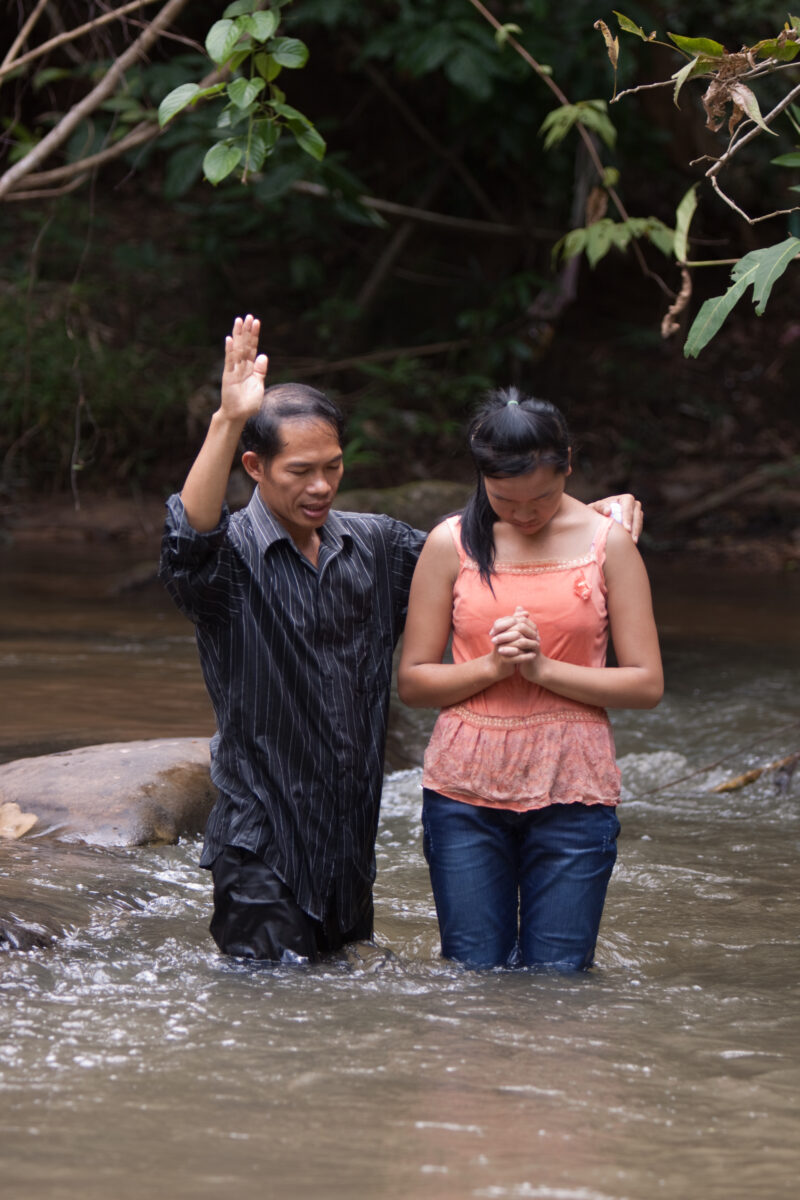 Christian Baptism in Laos — Young person becomes an Adventist Christian in the country of Laos, and is baptized in a mountian stream. — Laos, Southeast Asia,...