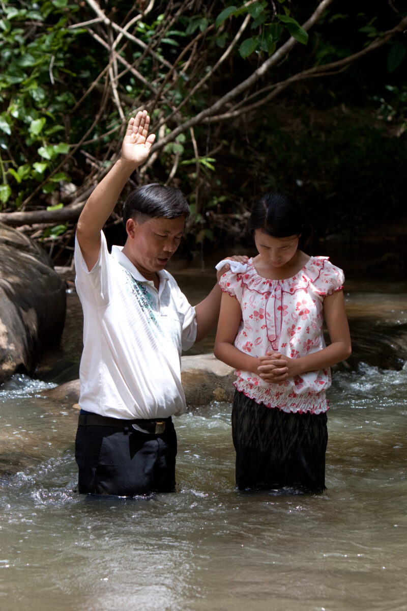 Christian Baptism in Laos — Young person becomes an Adventist Christian in the country of Laos, and is baptized in a mountian stream. — Laos, Southeast Asia,...